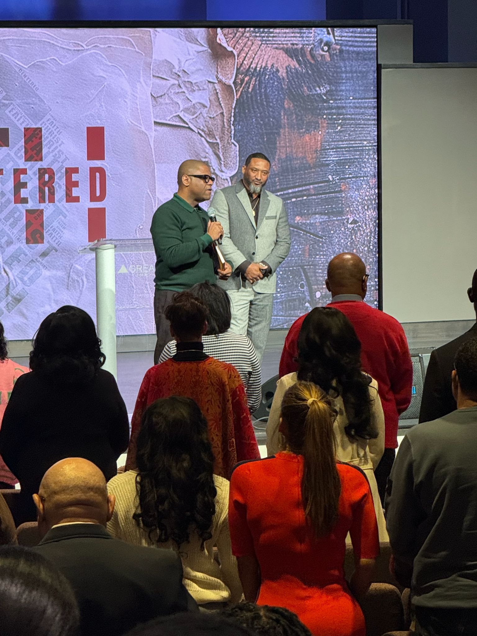 Mario Hall speaking at a live event